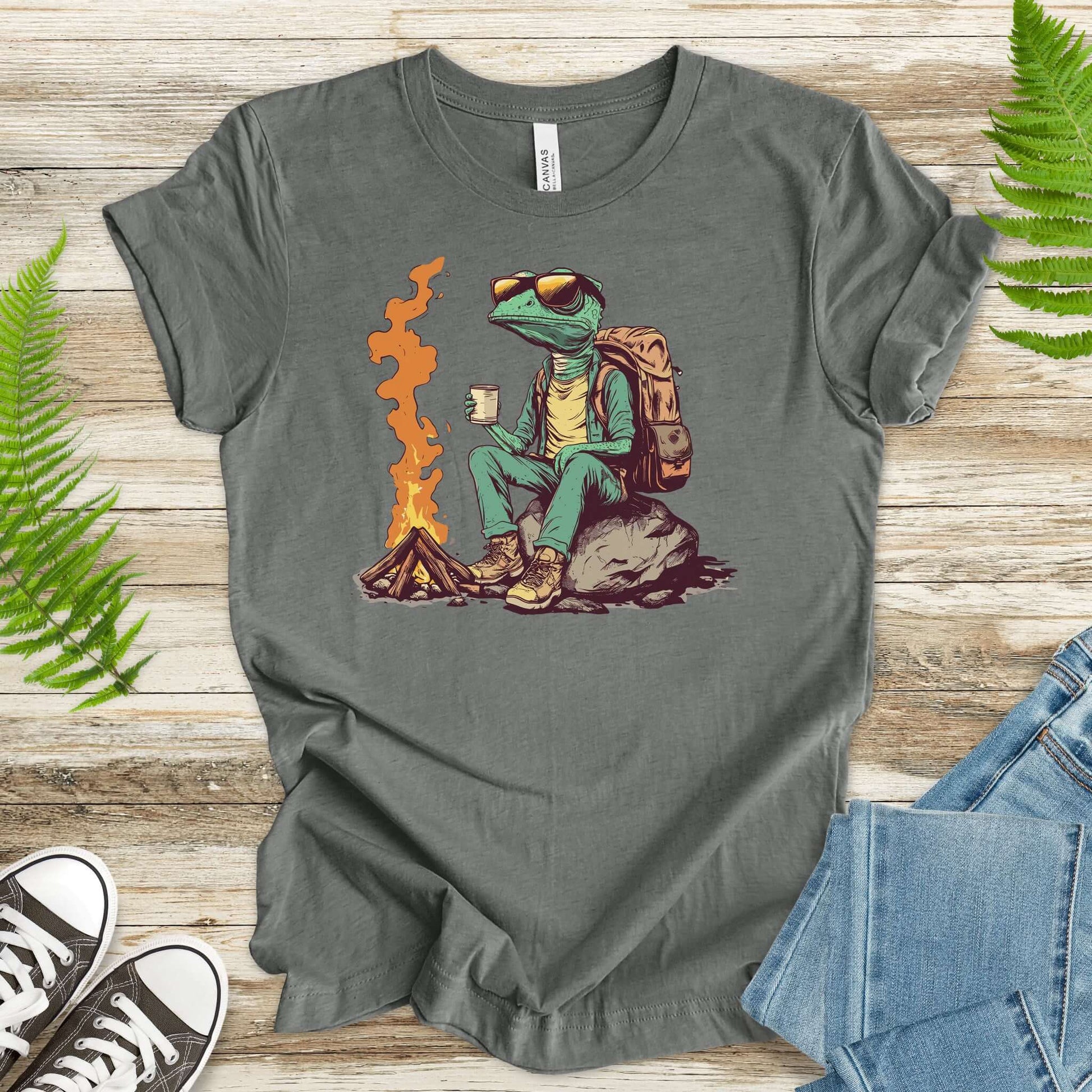 Chameleon sitting near a campfire t-shirt featuring a reptile relaxing with a kettle.