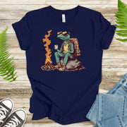 Chameleon sitting near a campfire t-shirt for nature lovers, featuring a cool chameleon in hiking gear.