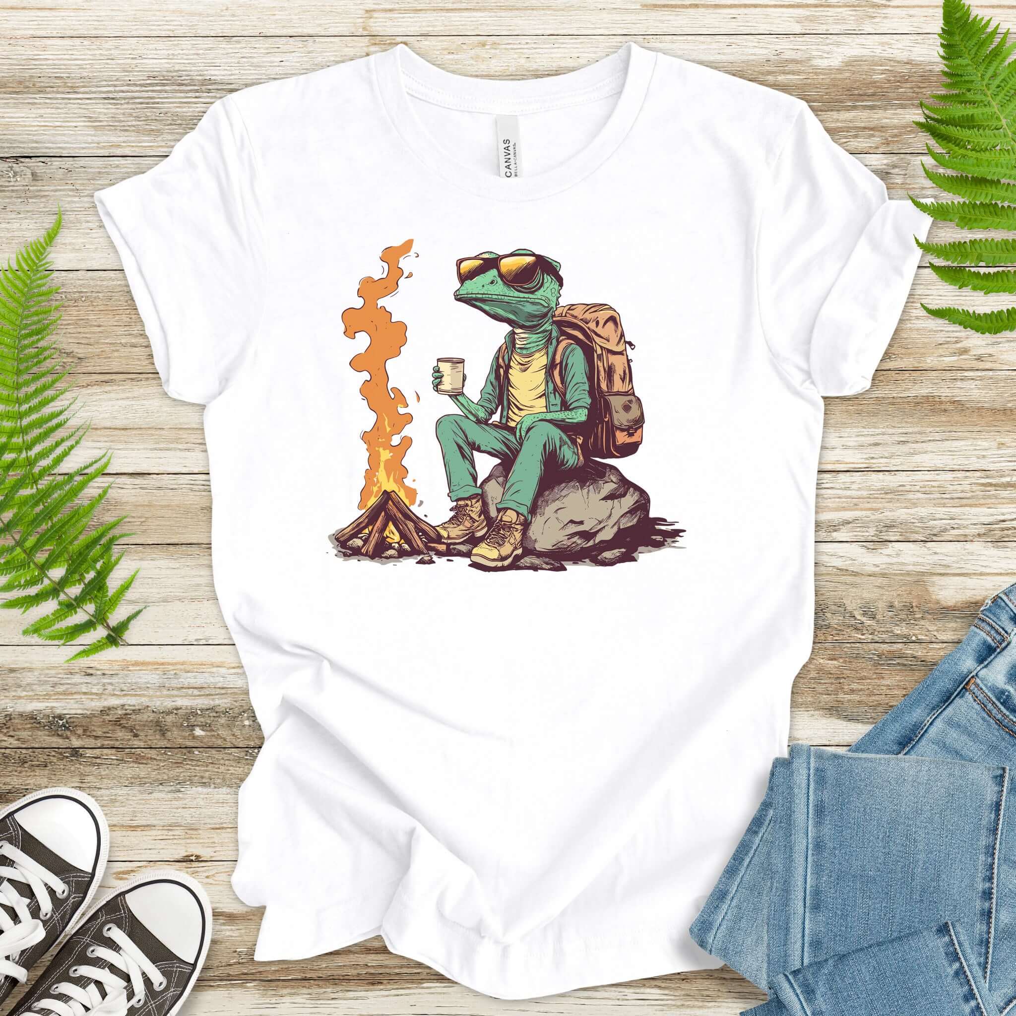 Chameleon sitting near a campfire t-shirt featuring a reptile in hiking gear enjoying a cozy brew.