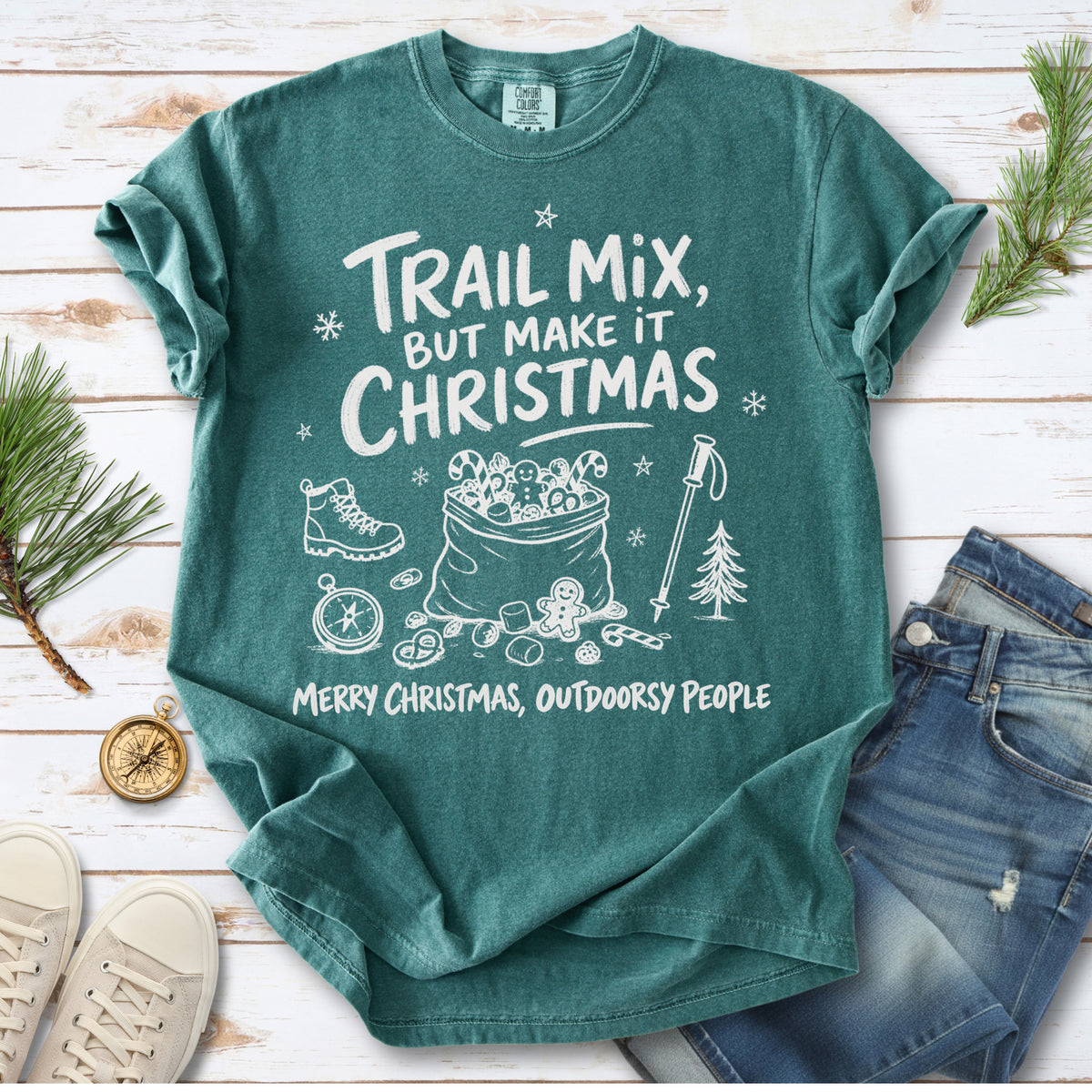 Festive trail snacks, candy canes, a gingerbread cookie, a hiking boot, compass, and trekking pole, doodle style design on a Blue Spruce T-shirt