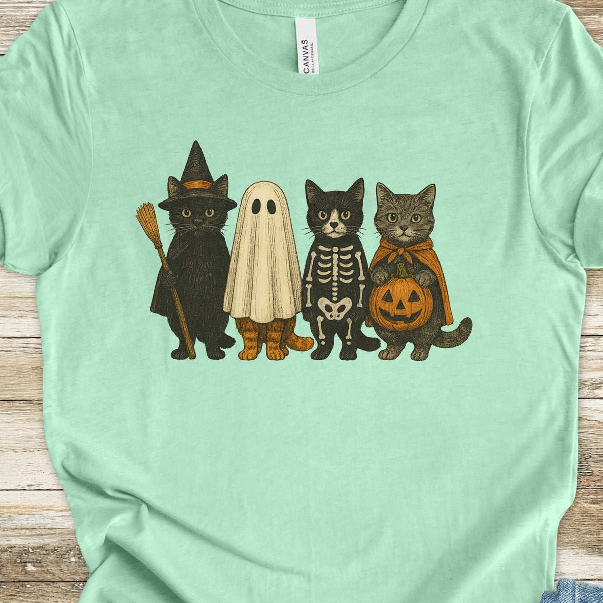 Cats dressed as a witch, a ghost, a skeleton, and a pumpkin, retro illustration on a Heather Mint T-shirt