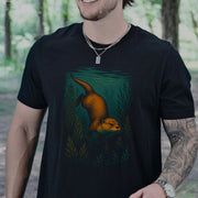 Otter Spirit Animal T-Shirt – Playful River Magic Vibes featuring an otter swimming in a forest stream.