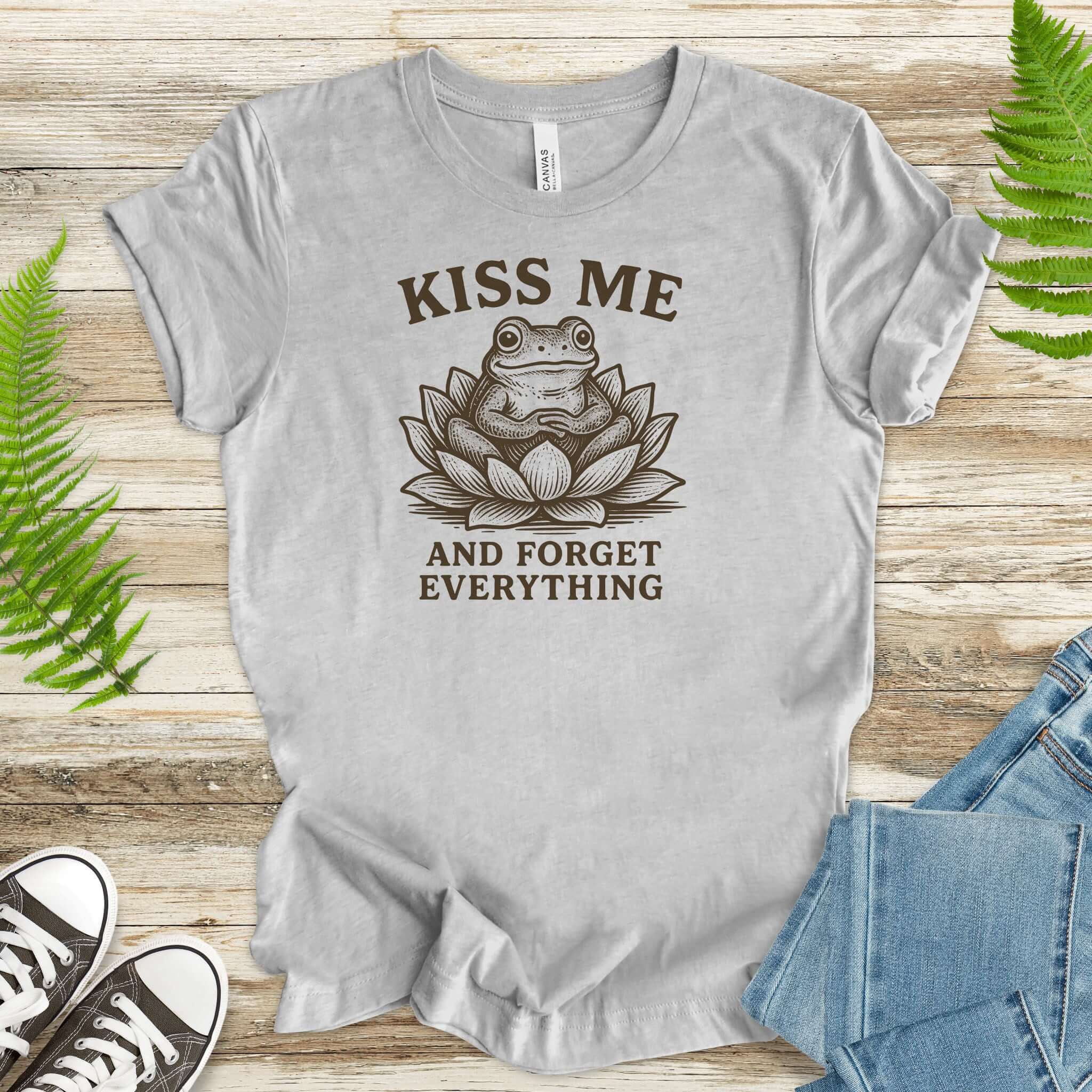 Funny frog t-shirt featuring a sassy frog in a lotus flower with "Kiss Me and Forget Everything" text.