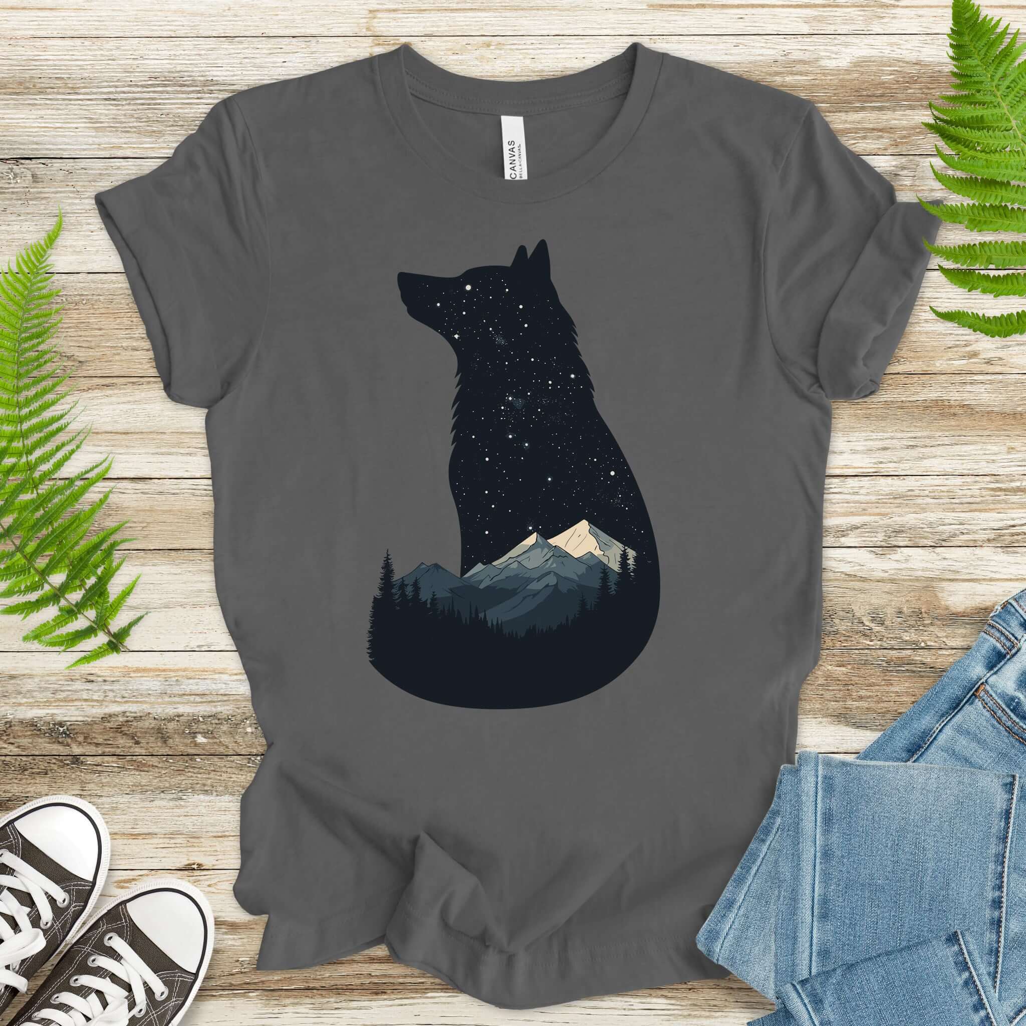 Wolf silhouette t-shirt with night sky, mountains, and a moonlit scene, perfect for nature lovers.