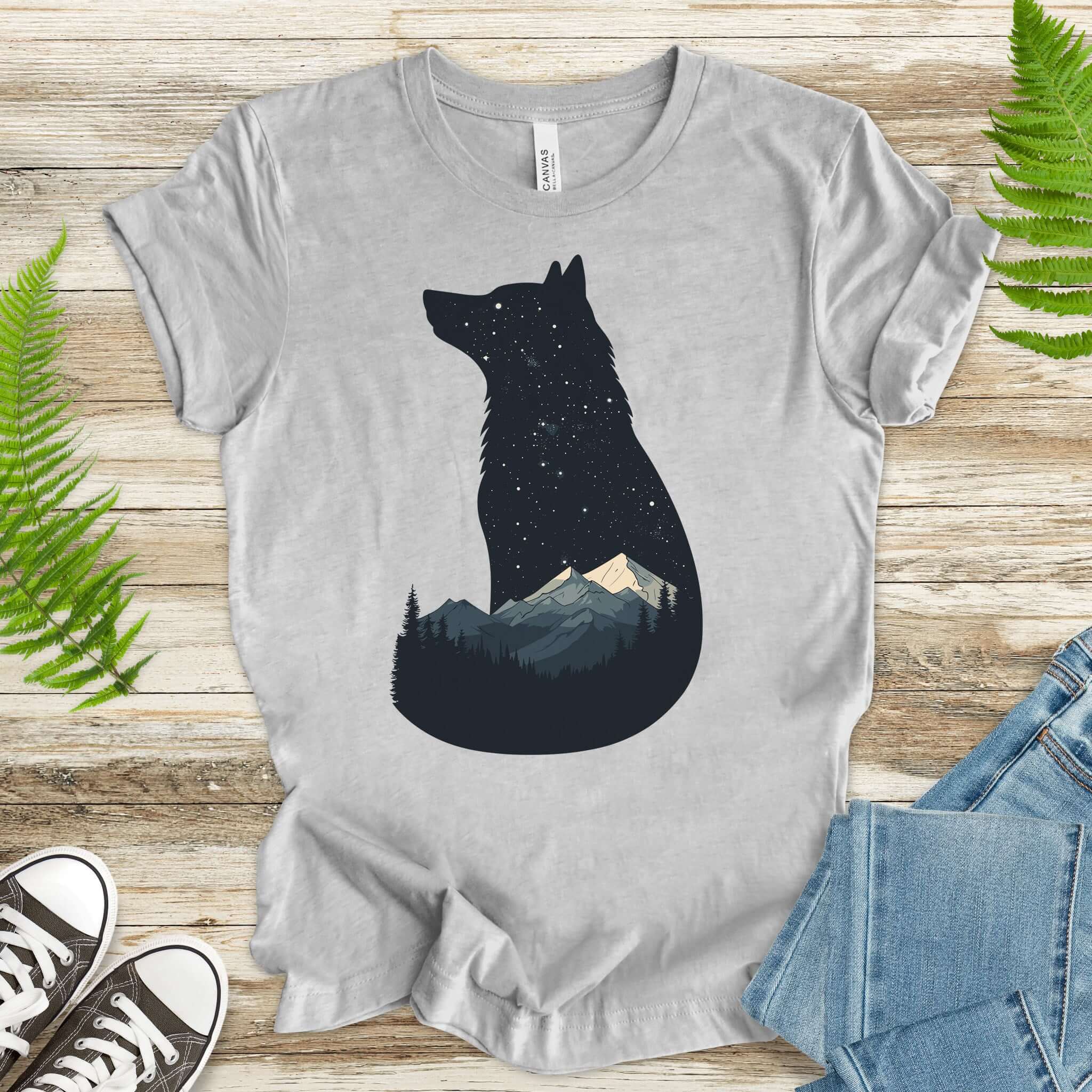 Wolf silhouette t-shirt with mountains and night sky, perfect for nature lovers and adventurers.