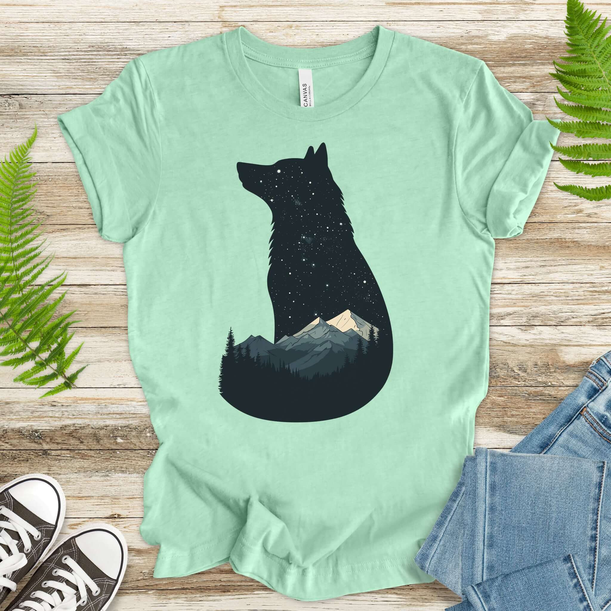 Wolf silhouette t-shirt with night mountain scene, moon, and starry sky, perfect for nature lovers.