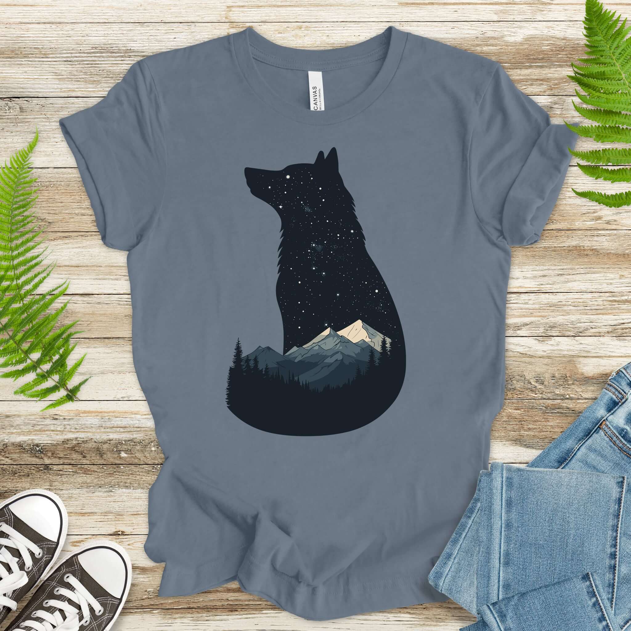 Wolf silhouette t-shirt with mountains and night sky design, perfect for nature lovers and adventurers.
