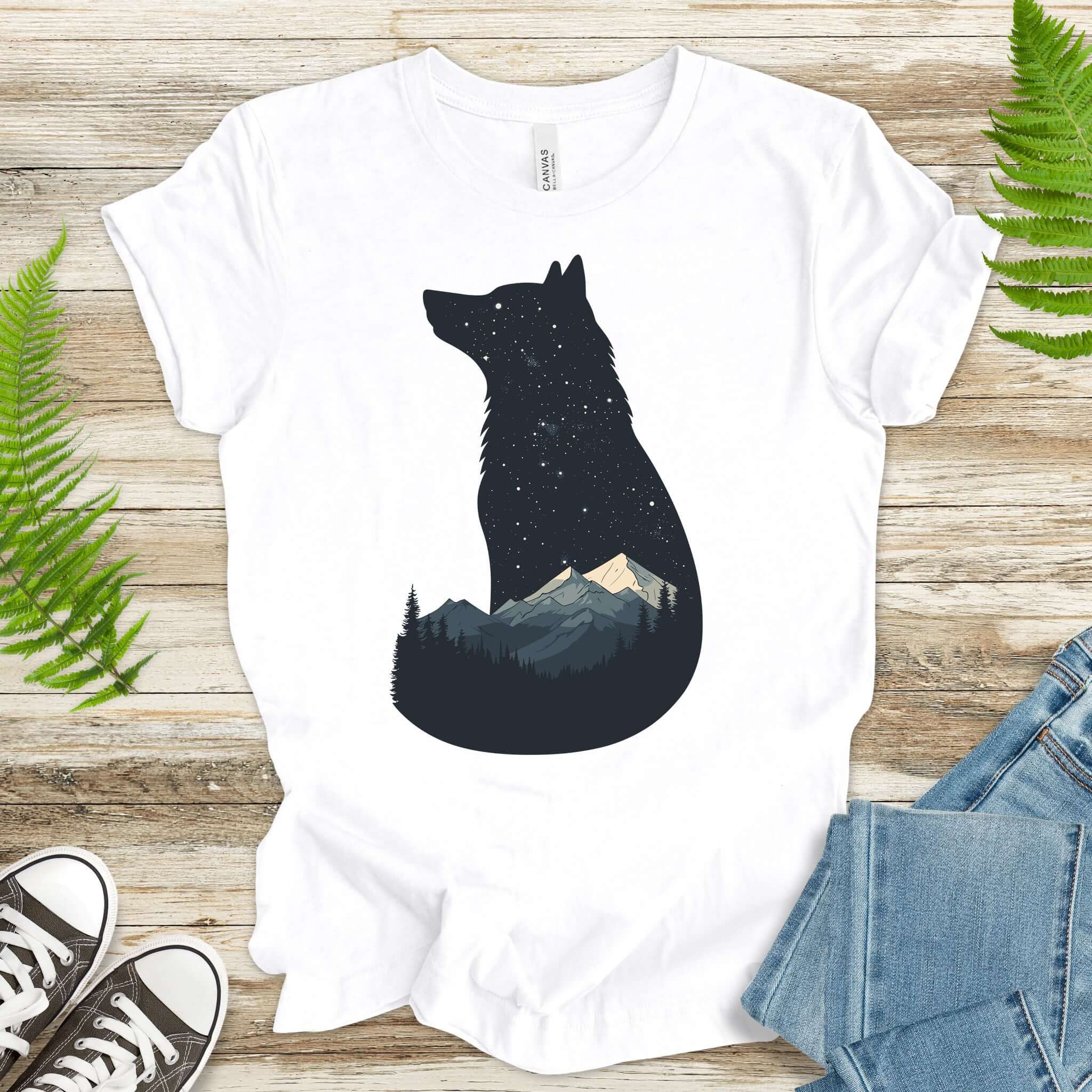 Wolf silhouette t-shirt with mountains and night sky, perfect for nature lovers and adventurers.