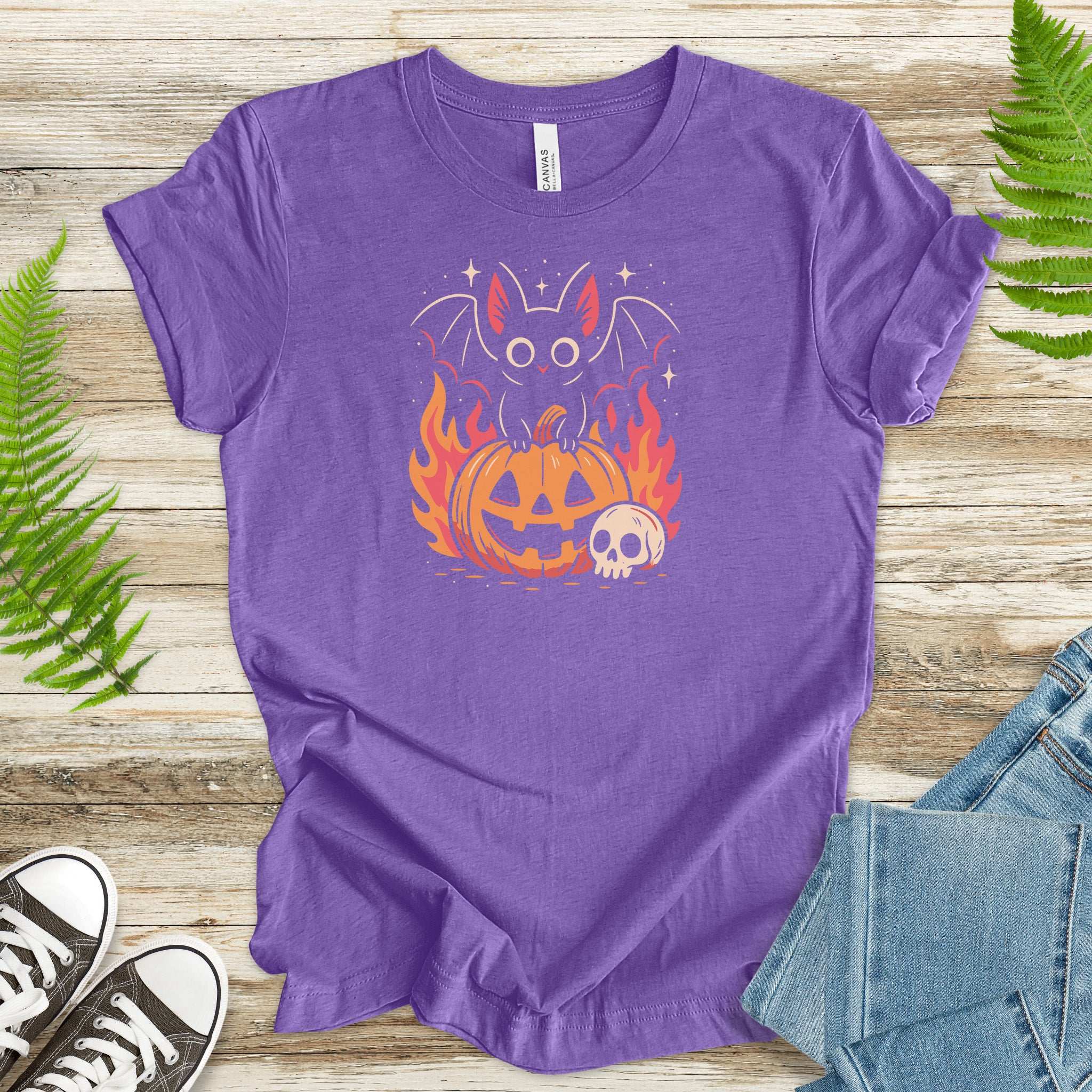 Spooky Bat Halloween T-Shirt featuring a cute gothic bat on a glowing jack-o'-lantern with flaming retro vibes.
