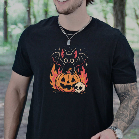 Spooky Bat Halloween T-Shirt featuring a cute bat on a fiery jack-o'-lantern, perfect for goths and pumpkin lovers.